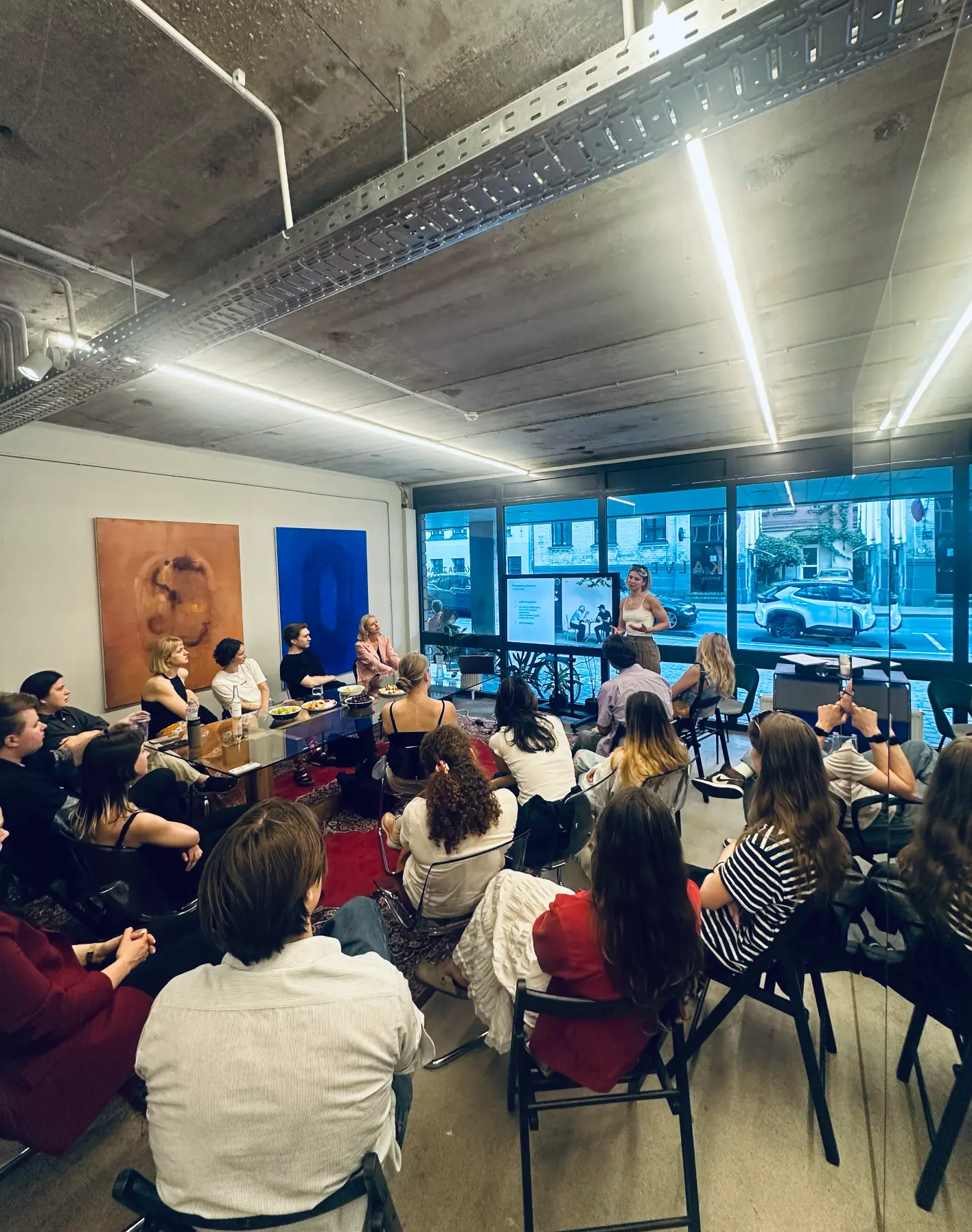 A Kalve Coffee feedback workshop in progress, with participants gathered around a table in a bright Riga studio